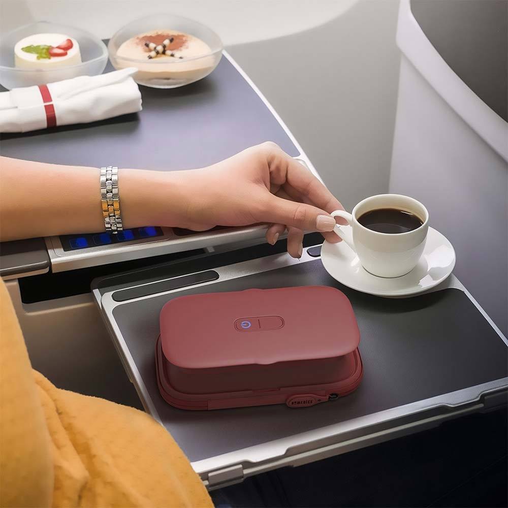 red UV-Clean Phone Sanitizer next to coffee on a tray